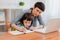 Mother and child school student at home on a laptop learning homework. e-home schooling during the period of the