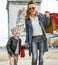 Mother and child with shopping bags in Paris going forward