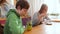 Mother and child are sitting in a cafe. Happy mother drinks coffee, her son drinks cocktail with straw. Parent and kid