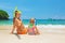 Mother with child snorkeling on summer beach holiday