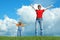 Mother and child stand on green grass