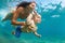 Mother with child swim underwater with fun in sea
