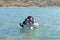 Mother and child swimming in sea in Greece
