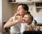 Mother and child tasting whipping cream