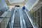 Mother and child together on escalator background. Terminal, airport travel, love care.