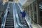 Mother and child together on escalator background. Terminal, airport travel, love care.