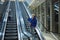 Mother and child together on escalator background. Terminal, airport travel, love care.