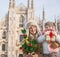 Mother and child tourists with Christmas tree and gift in Milan