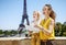 Mother and child tourists holding map and pointing. Paris