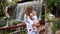 Mother and child walk around the waterfall during a tour of the Canary Islands