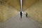 Mother and child walking through an underpass