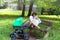 Mother and child, young mom is parenting her little toddler, woman breastfeeding and holding her baby, sitting on a park bench