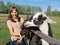 Mother with child and young white llama on green field.