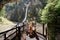 Mother with children against waterfall in Liechtensteinklamm or Liechtenstein Gorge, Austria