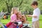 Mother with children and bicycle in park