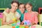 Mother with children collecting plastic blocks