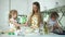 Mother With Children Cooking Dough At Kitchen