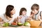 Mother and children cooking at the kitchen