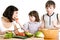 Mother and children cooking at the kitchen