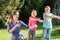 Mother with children daughters doing dance exercise outdoors