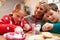 Mother And Children Decorating Christmas Cookies Together