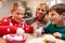 Mother And Children Decorating Christmas Cookies Together