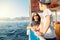 Mother with children enjoys travel on boat sailing in sea