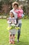 Mother And Children Holding Basket Of Daffodils