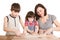 Mother and children in the kitchen making a dough