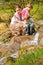 Mother with children look on little waterfall