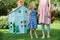 Mother And Children Playing With Home Made Cardboard House