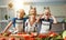 Mother with children preparing vegetable salad