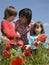 Mother and children in red poppy