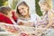 Mother And Children Relaxing In Garden Hammock Together