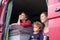 Mother and children sitting on the side of their campervan