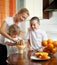 Mother with children squeezed orange juice