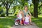 Mother And Children With Tricycle In Park