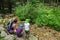 Mother with children on a trip in the wood.