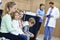 Mother and children waiting in front of registration desk in hospital