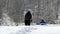 Mother with children walking in snow drifts