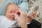 Mother cleaning eyes of a newborn baby