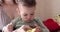 Mother combing the hair on the baby head as he sits in the mother arms