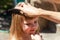 Mother combing her daughters hair, child being combed by her mom using a black comb, closeup, portrait. Woman doing happy little