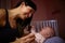 Mother Comforting Crying Baby In Nursery