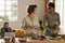 Mother cooking together with her adopted daughter