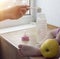 Mother cooks baby food for the child, a close up, a hand and a small bottle