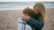 Mother cover blanket kid on cold beach picnic closeup. Unconditional parent love