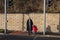 A mother crossing the road at traffic lights with her young child