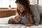 Mother cuddles tickles little daughter lying in bed feels happy