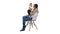 Mother and cute baby sitting on a chair on white background.